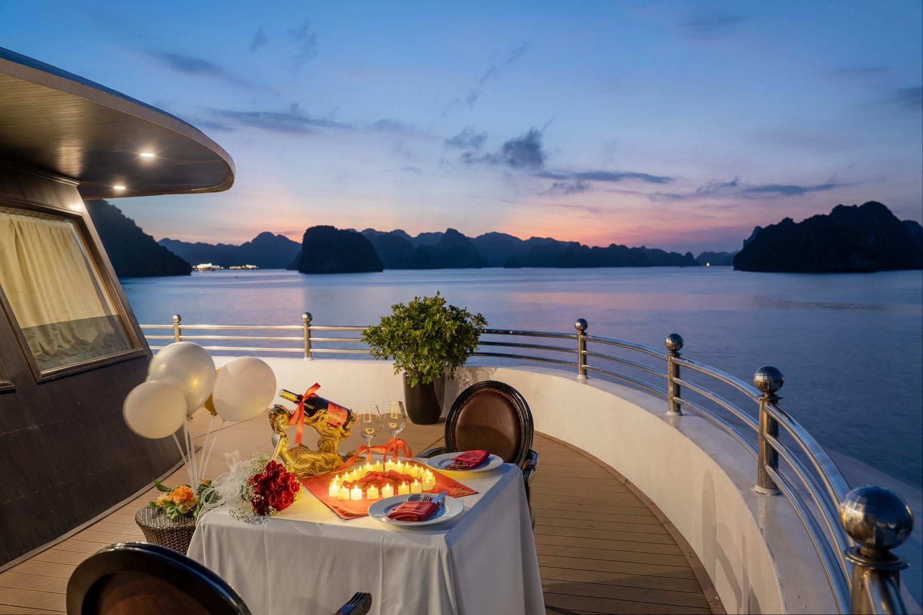A private dinner laid for two on the Athena Luxury deck at sunset