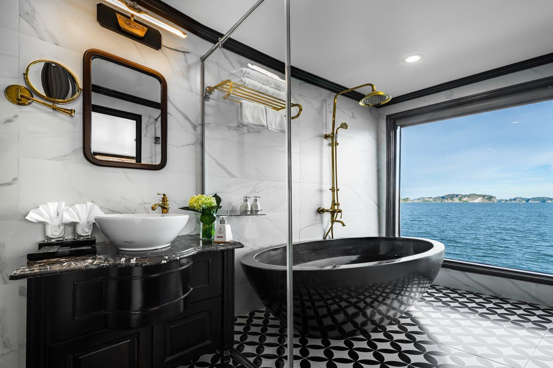 A freestanding black bathtub set against the window in the Premium Terrace cabin