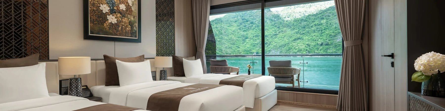 Twin beds in an Azura Cruise cabin with the bay framed in the window