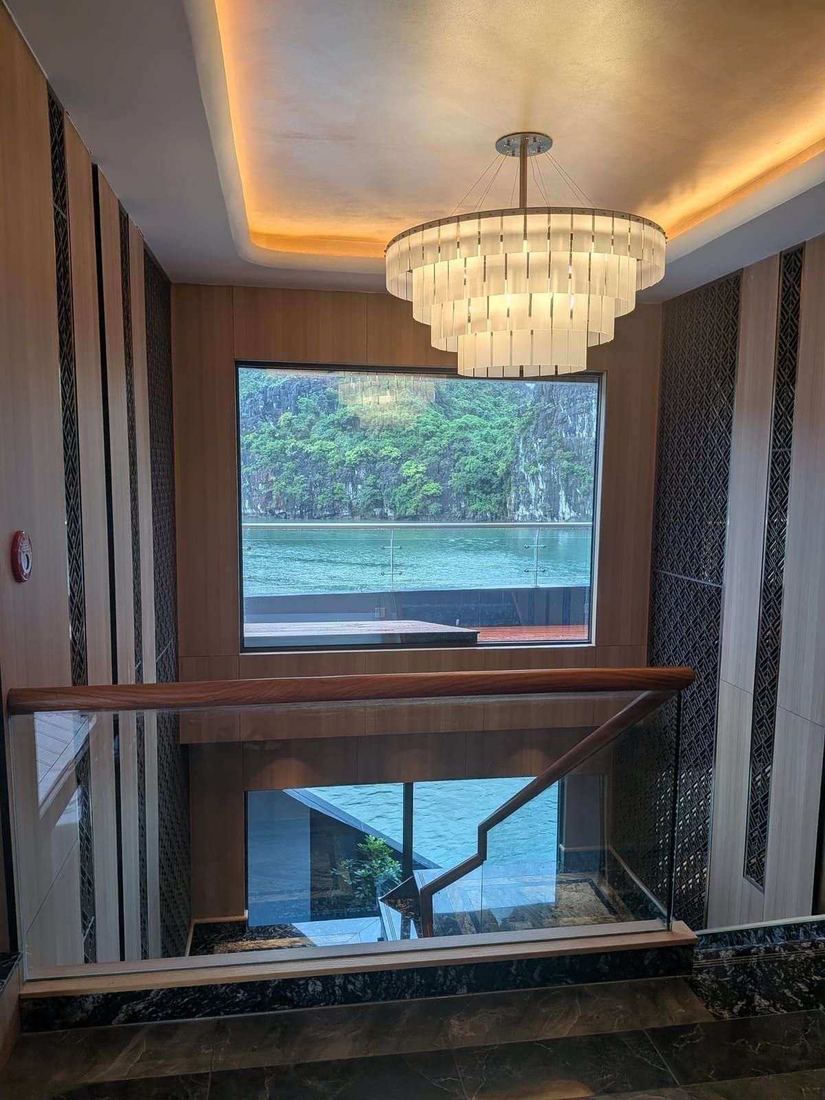 The chandelier and marble stairwell inside Azura Cruise