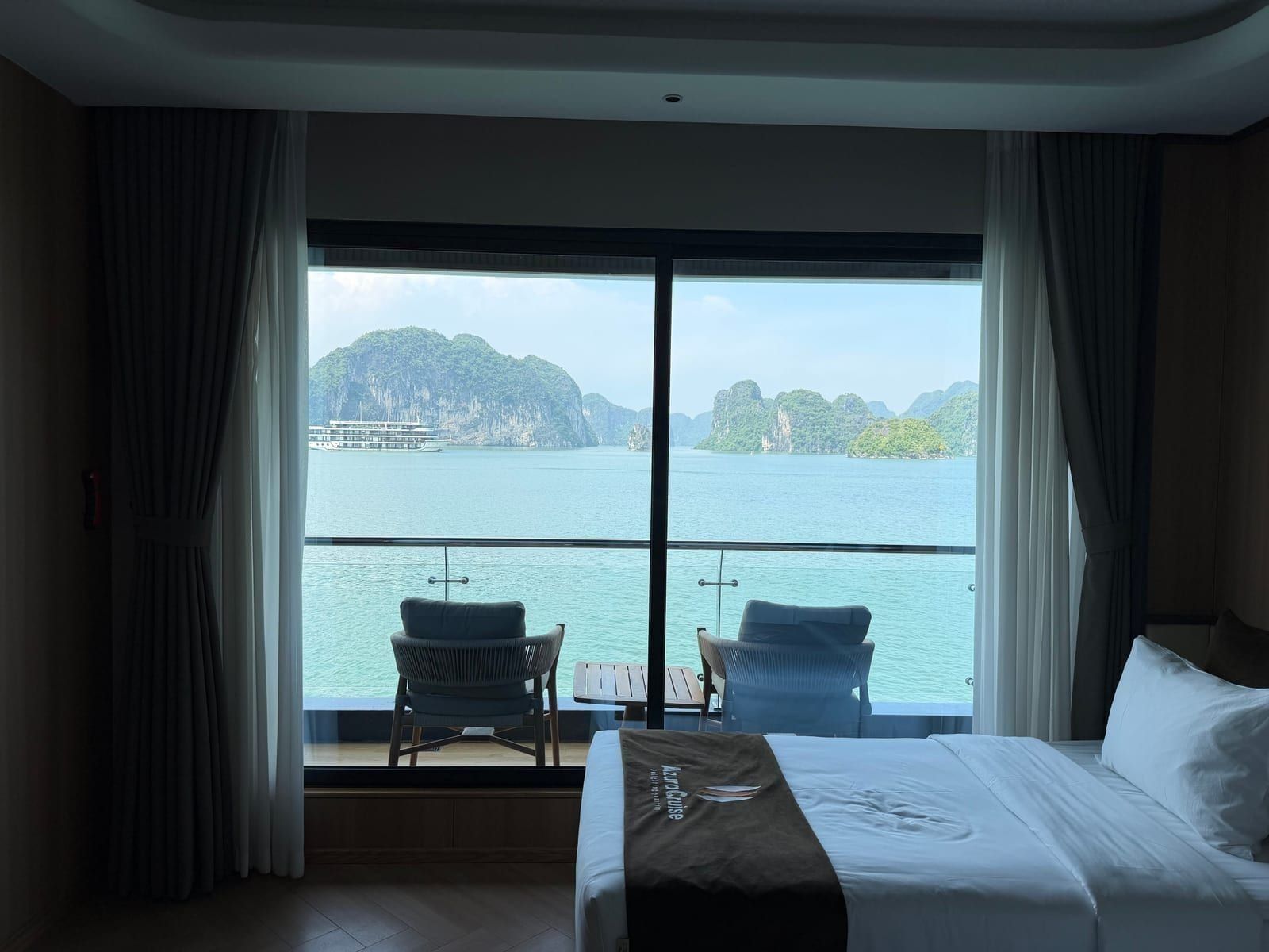 An Azura Cruise cabin with floor-to-ceiling windows over the water