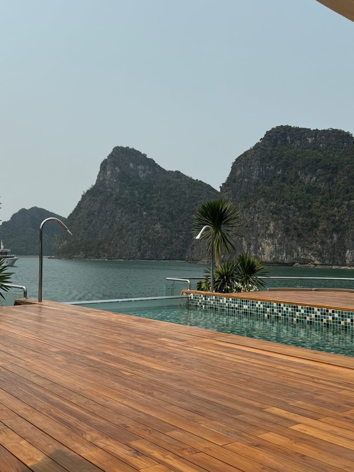 The Azura Cruise infinity pool running to the edge of the teak deck