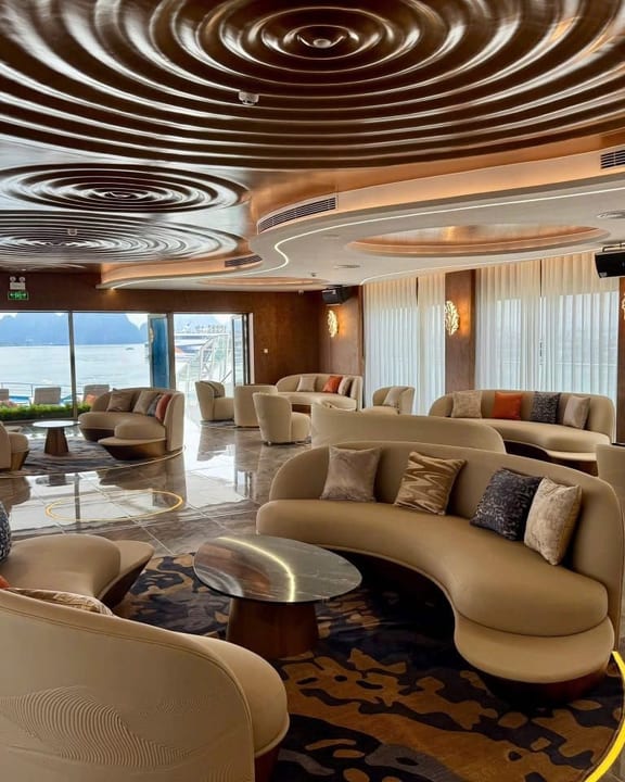 The Athena Premium lounge, curved seating beneath a spiralled ceiling