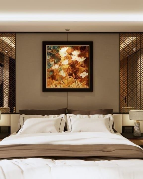 An Azura cabin made up for the evening beneath a framed painting